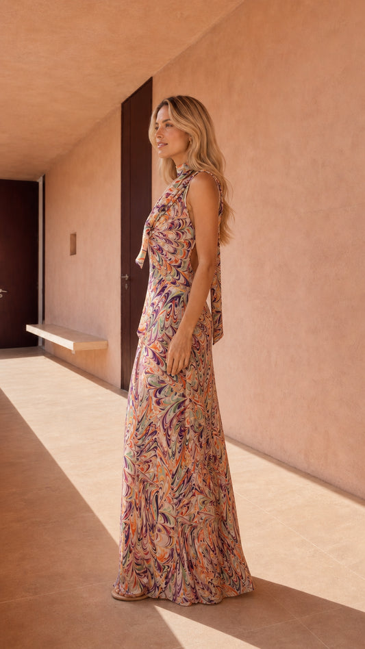 Side profile of model in abstract print maxi dress