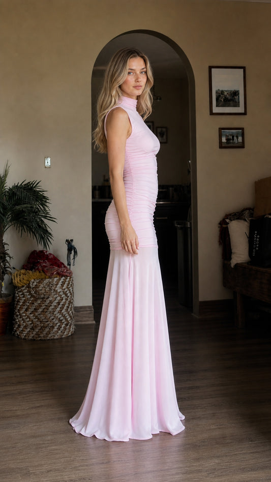 Side profile view of model wearing pink ruched mermaid dress