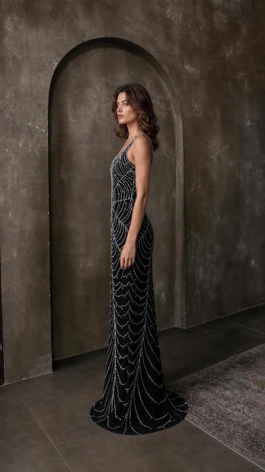 Side profile view of black beaded evening dress