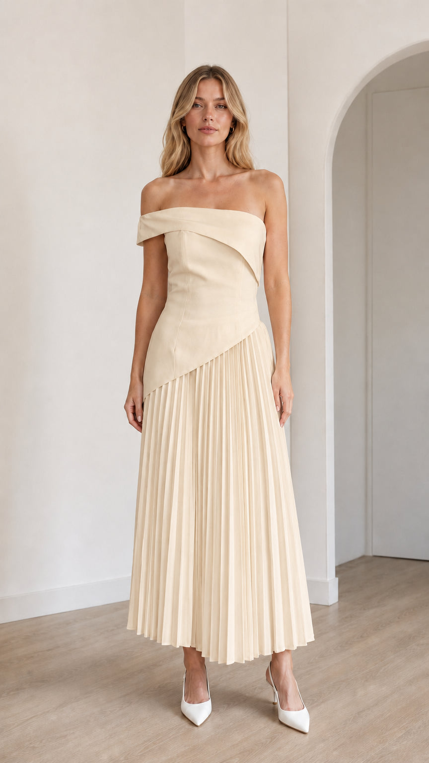 Model wearing champagne off-shoulder asymmetric pleated midi dress
