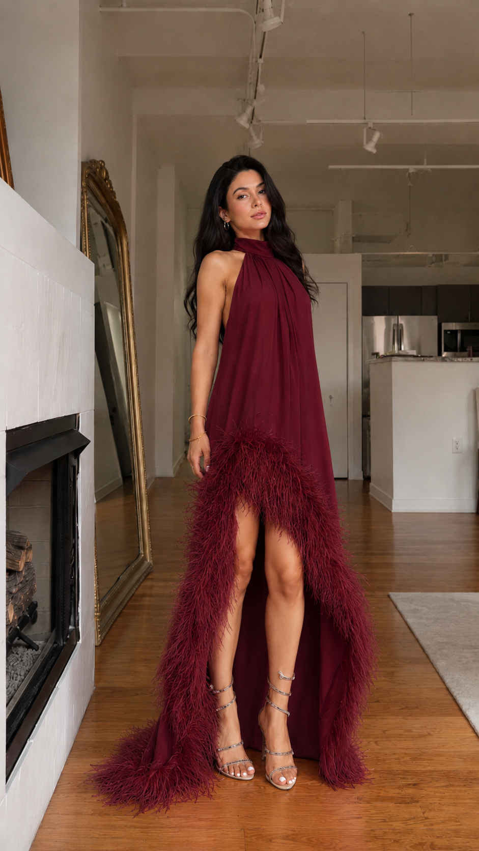 Front view of burgundy halter high-low maxi dress with feather-trim hem