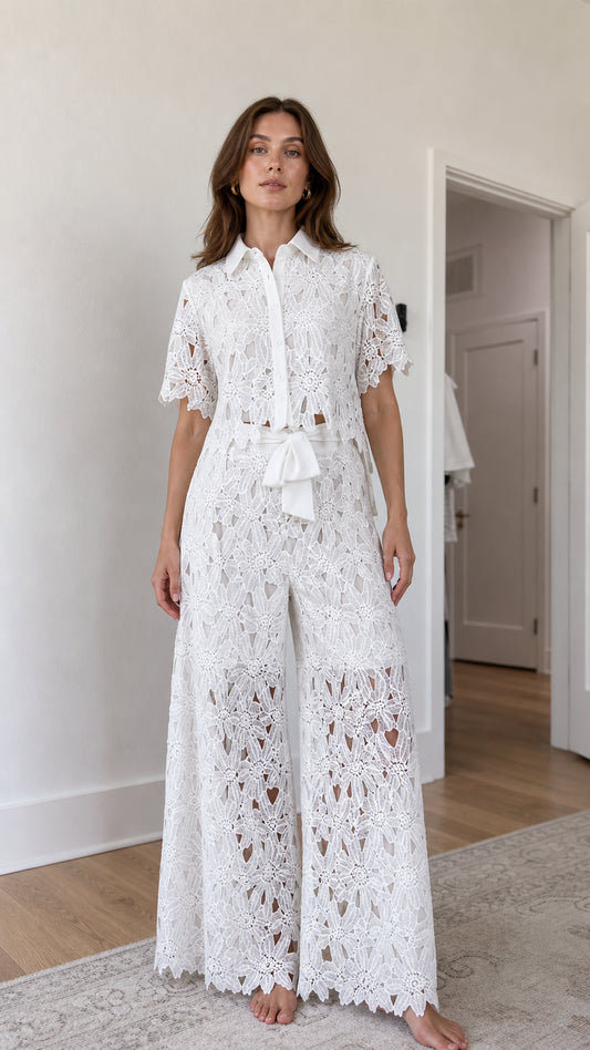 Front view of woman wearing white floral lace shirt and wide-leg pants set