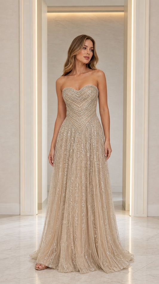 Front view of model wearing Champagne strapless beaded evening gown