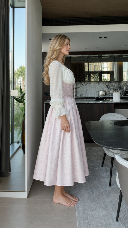 Side profile view of model wearing pink vintage corset midi dress