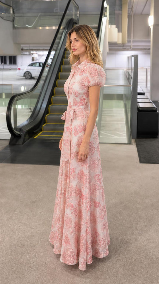 Side profile view of woman in pink floral maxi dress