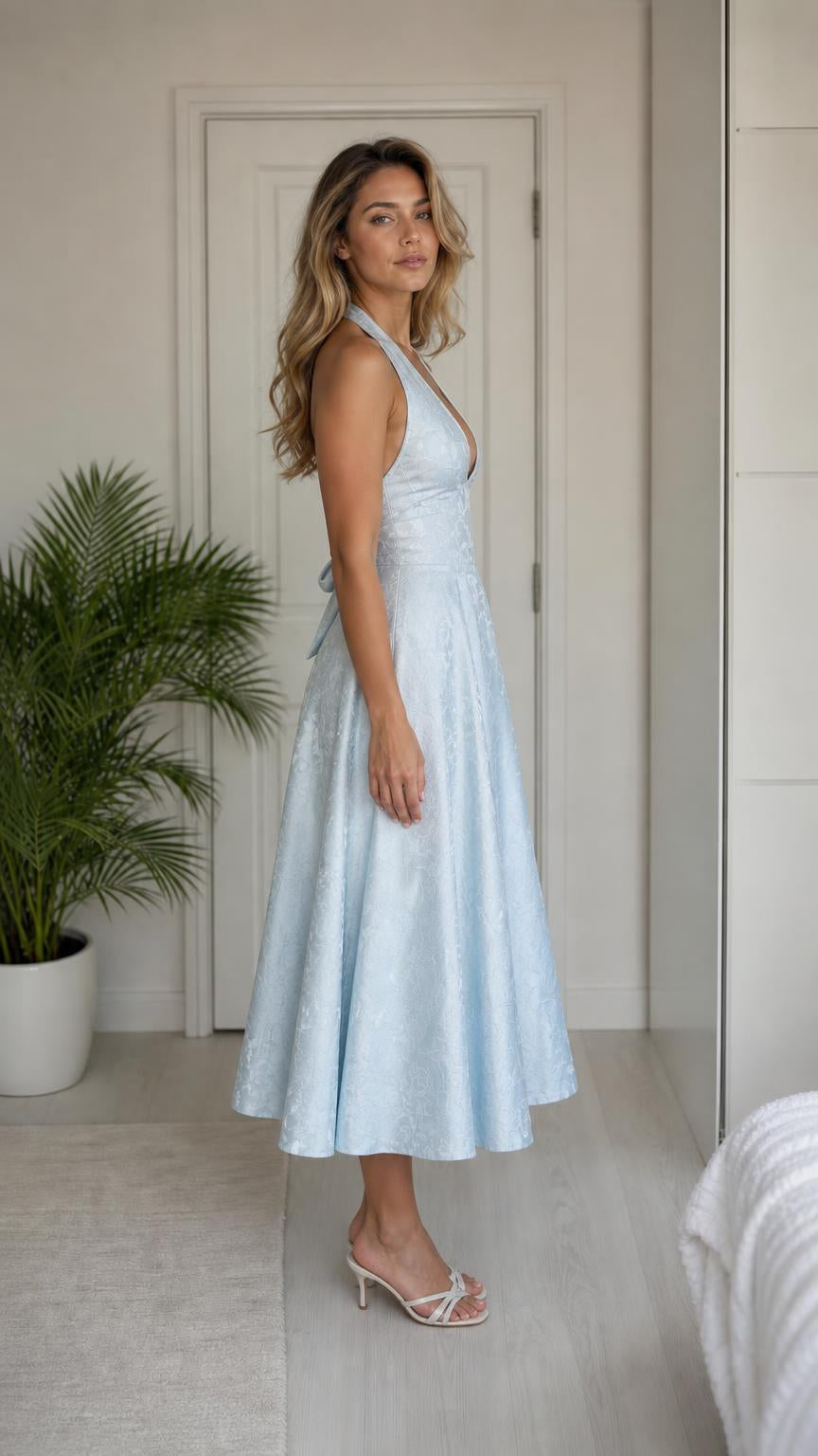 Side profile view of light blue halter midi dress