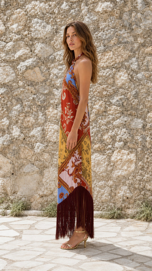 Side view of model wearing Multicolor paisley halter fringe maxi dress