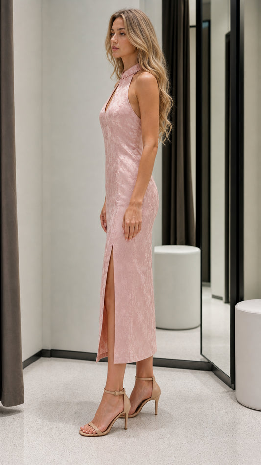 Side profile view of pink midi dress with high slit