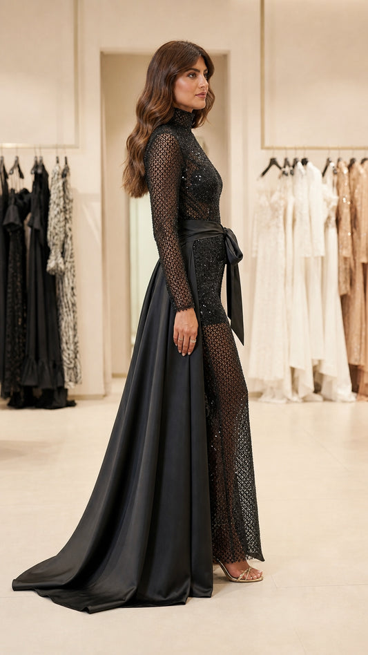 Side profile view of black sequin jumpsuit and flowing satin train