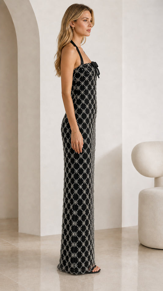 Side profile view of black rhinestone halter maxi dress