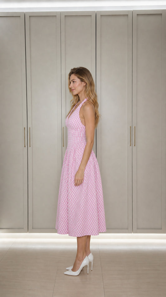 Side profile of model in pink gingham midi dress
