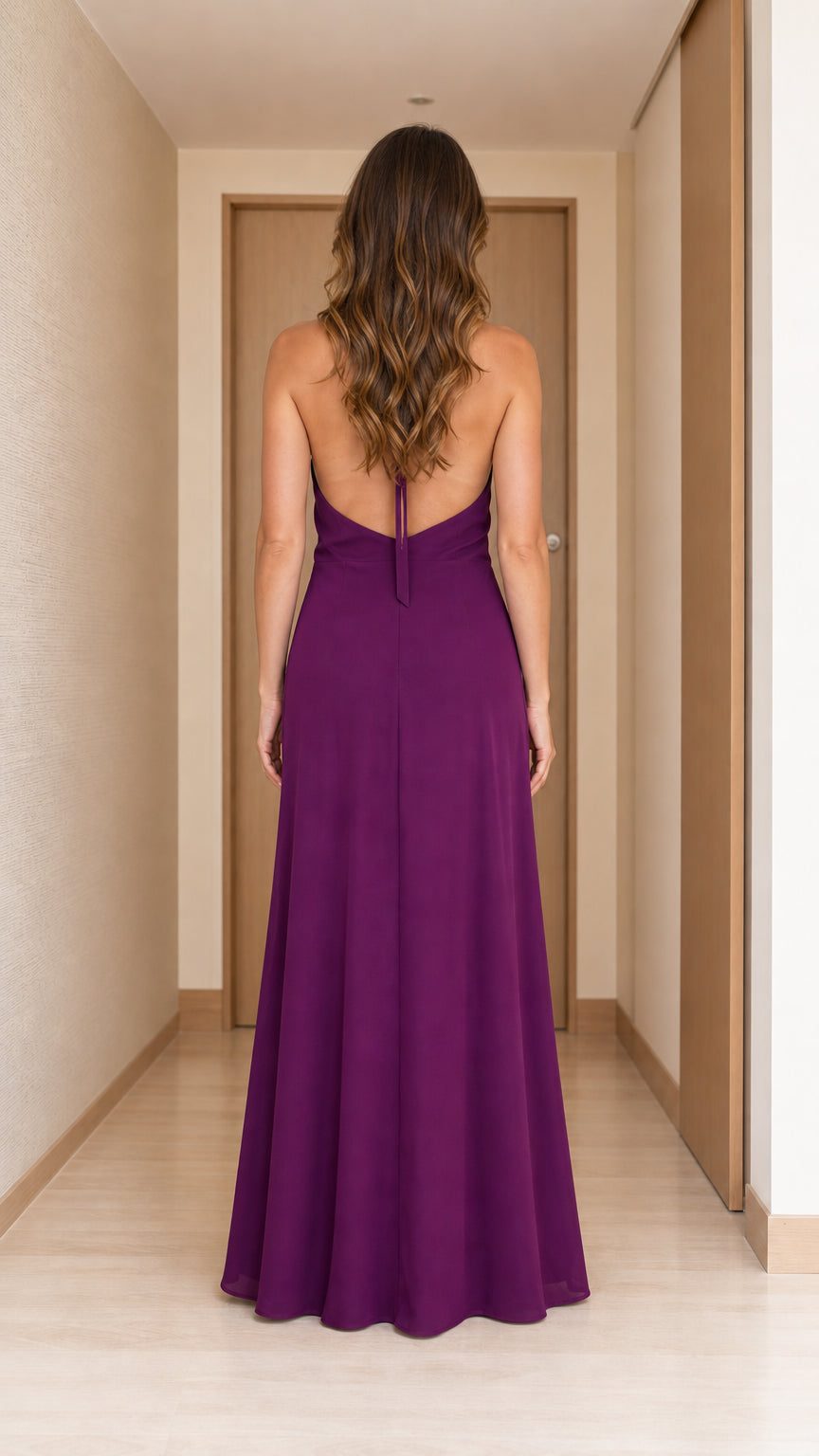 Back view of woman in purple halter neck maxi dress
