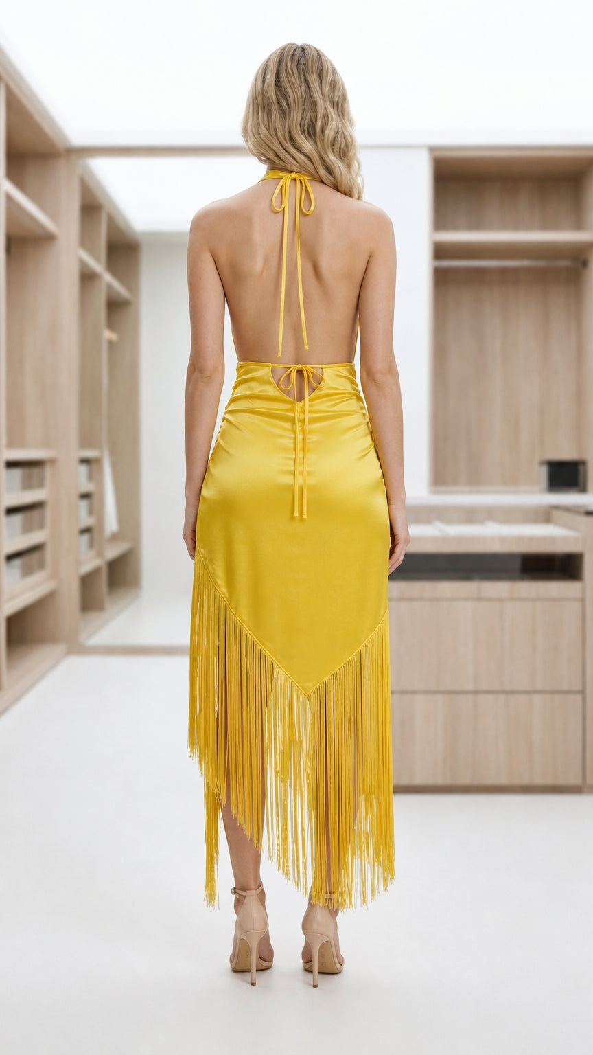 Back view of model showing open back and halter ties of yellow dress