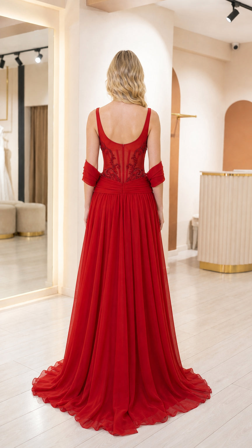 Back view of woman in red formal gown showing back neckline and draping