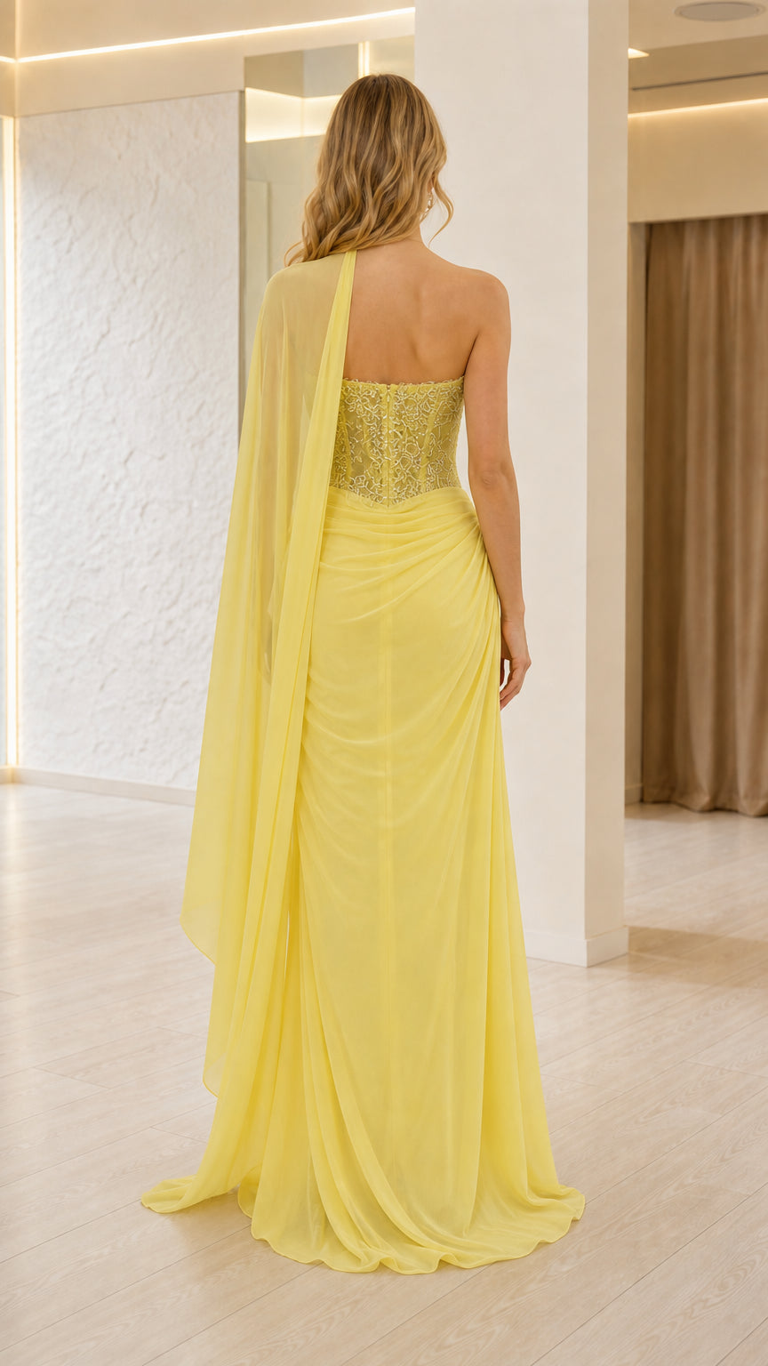 Back view of the lemon yellow lace corset maxi dress with flowing sheer cape