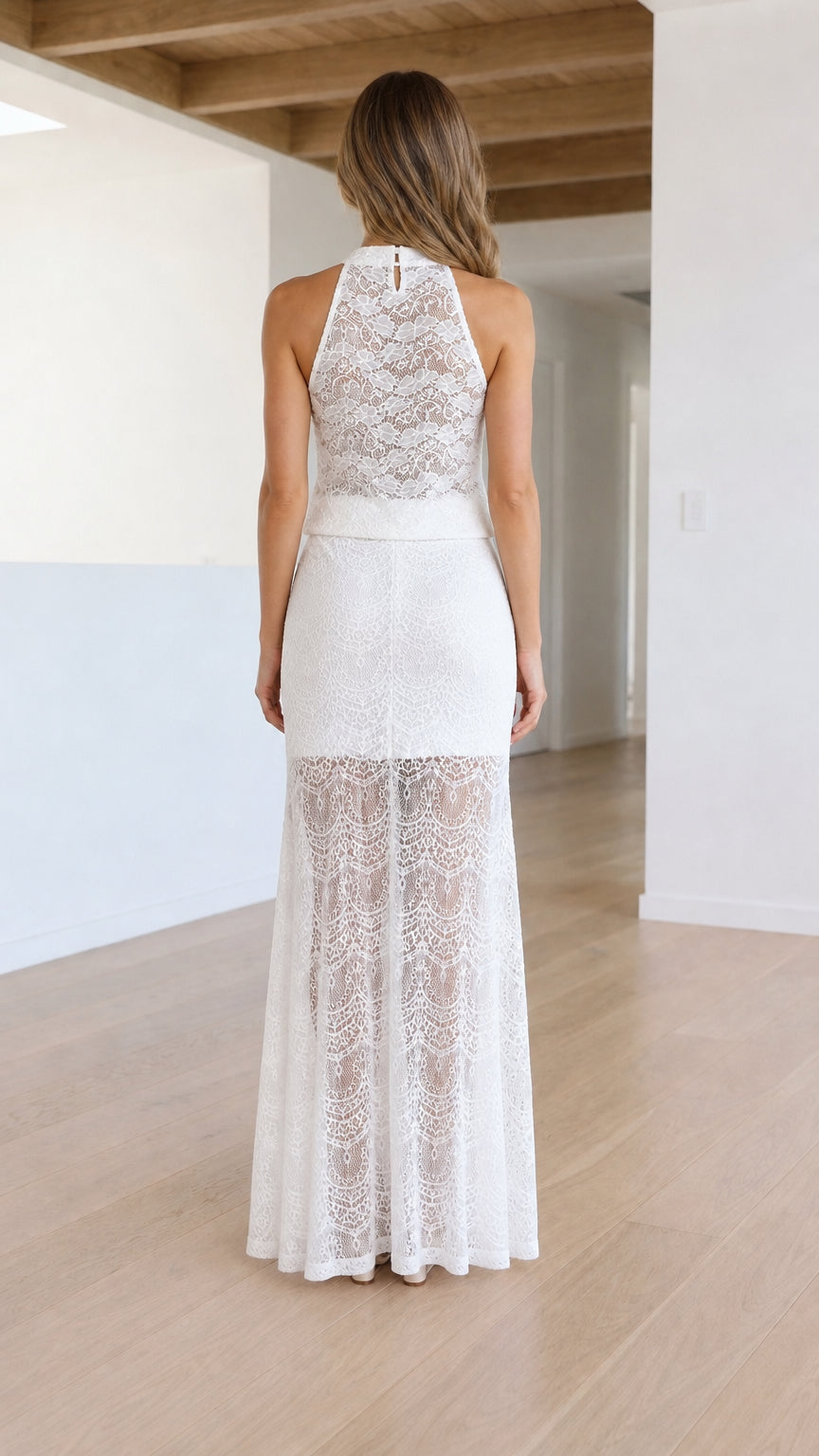 Back view of model showing lace detailing on white maxi dress