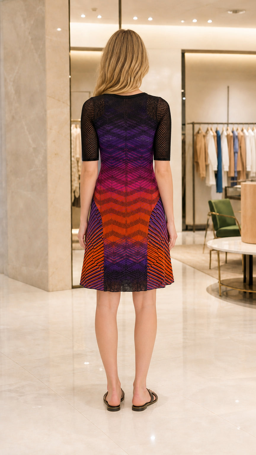 Back view of model in multi-color ombre chevron knit dress