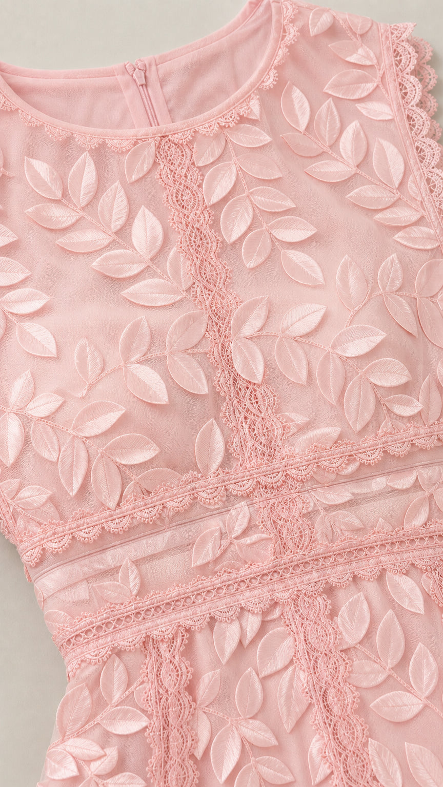 Close-up detail of bodice, neckline, and leaf embroidery on pink dress