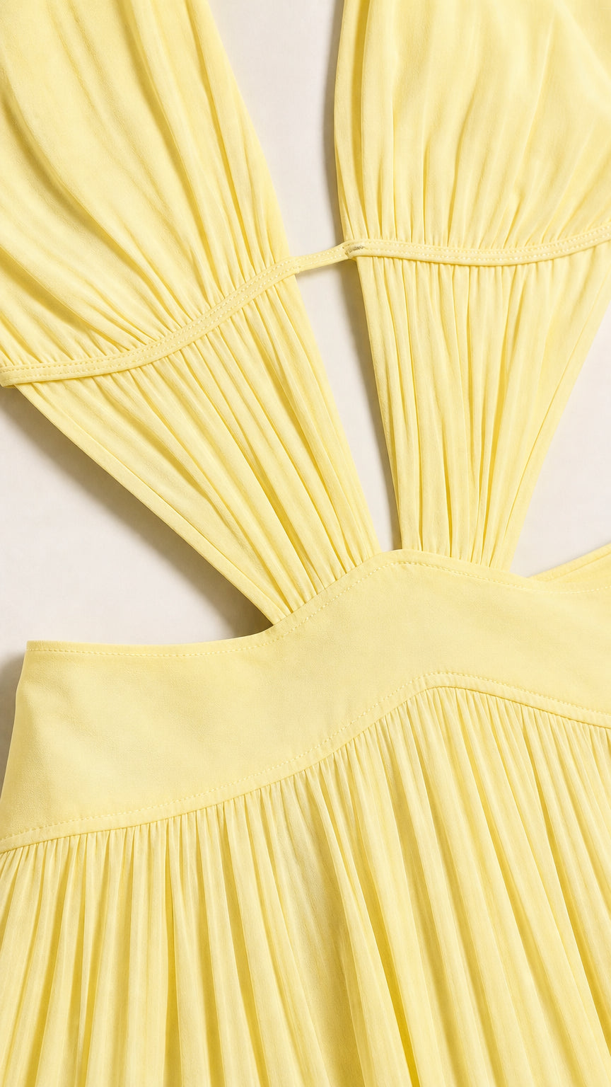 Close-up detail of front bodice and waist cutout on yellow dress