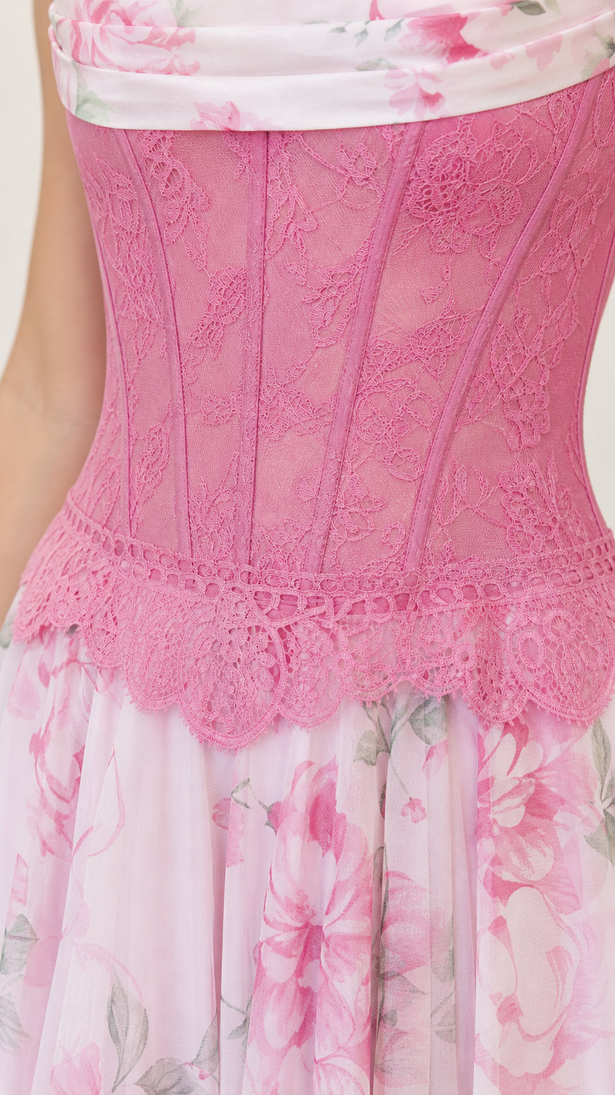Close up of pink corset bodice and floral skirt detail