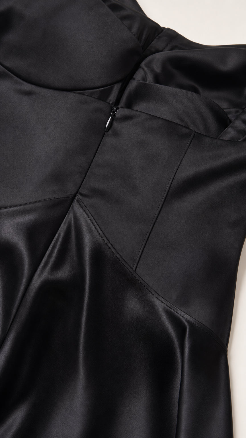 Close-up of bodice construction and side zipper on black satin dress