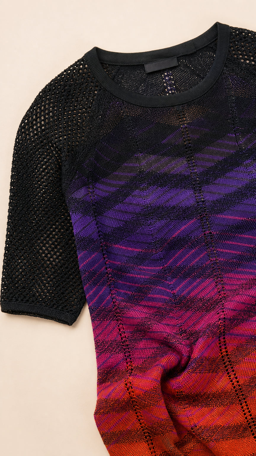 Close-up flat lay showing knit texture and gradient detail of the dress