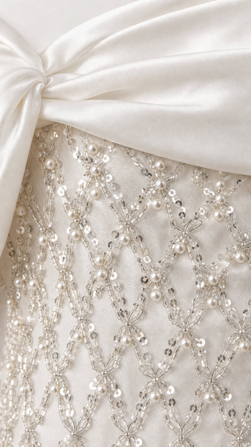 Close-up detail of satin fold and lattice beadwork