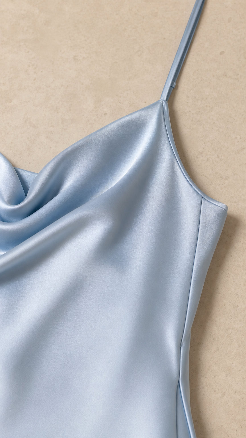 Close-up detail of smooth satin fabric and spaghetti strap