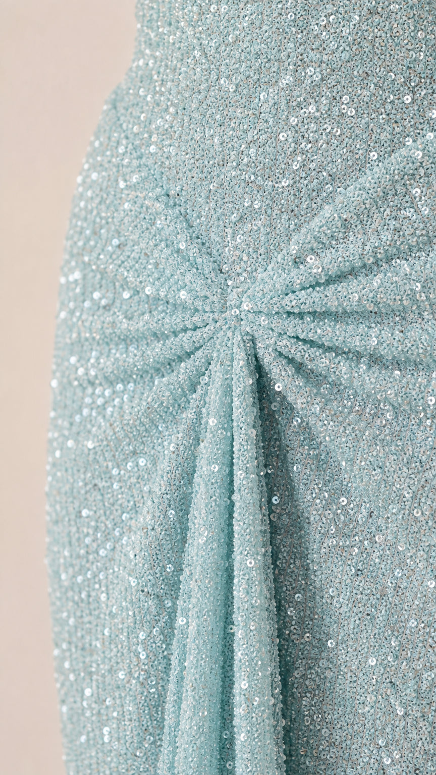 Close-up detail of front gathered knot and sequin texture on light blue dress