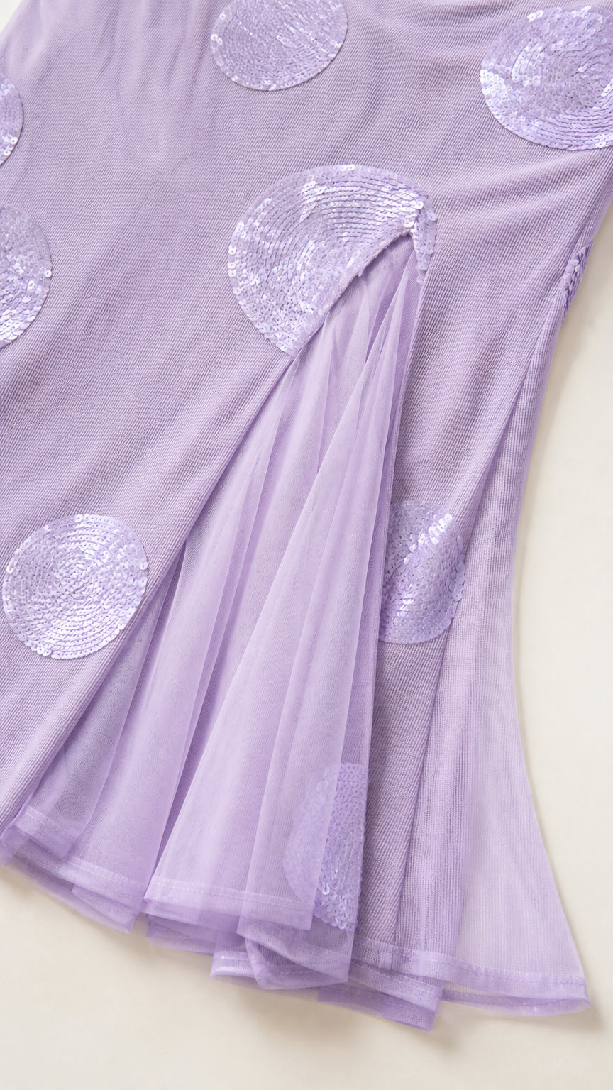 Close-up detail of sequin polka dots on mesh hem