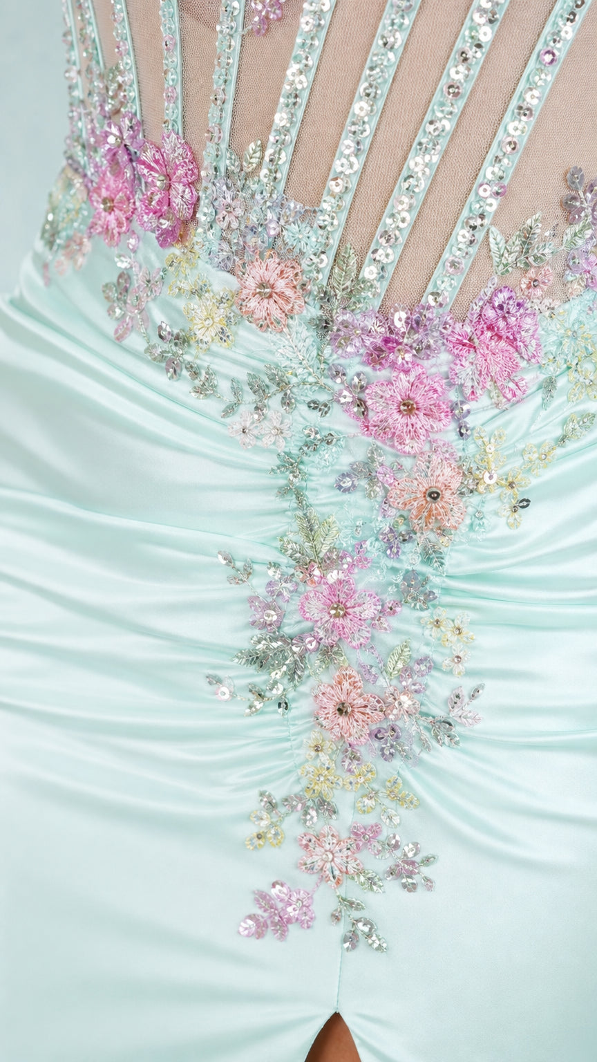 Close-up of floral applique and beadwork on mint dress