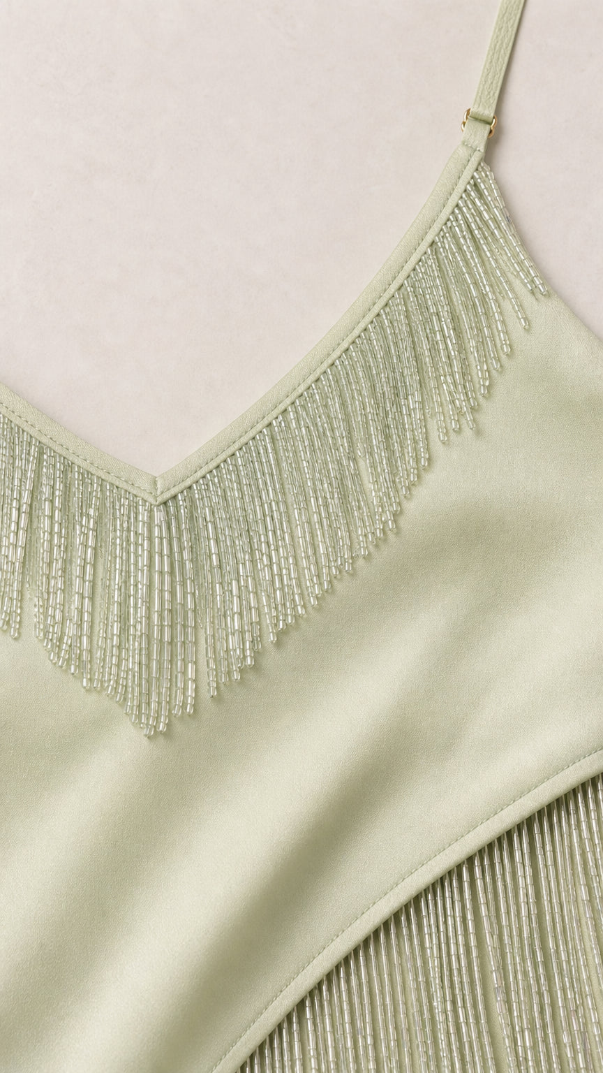 Close-up of mint beaded fringe neckline and pleated detail
