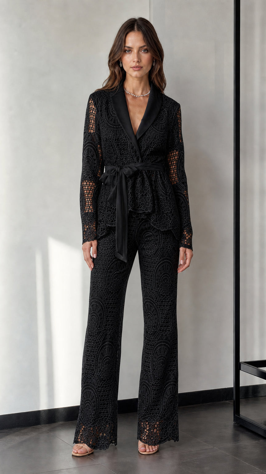 Woman wearing black lace blazer and trousers set