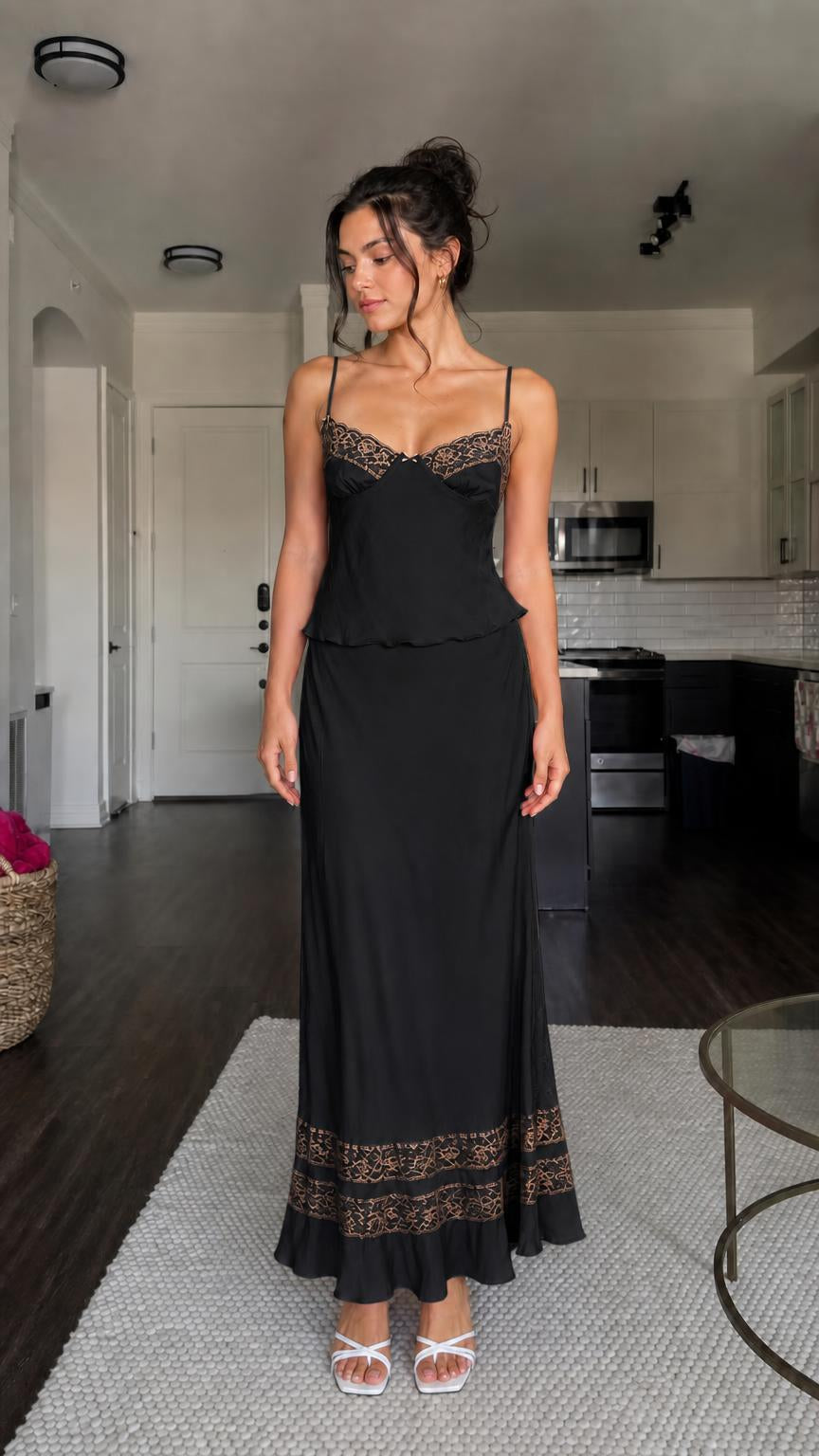 Model wearing black two-piece satin set