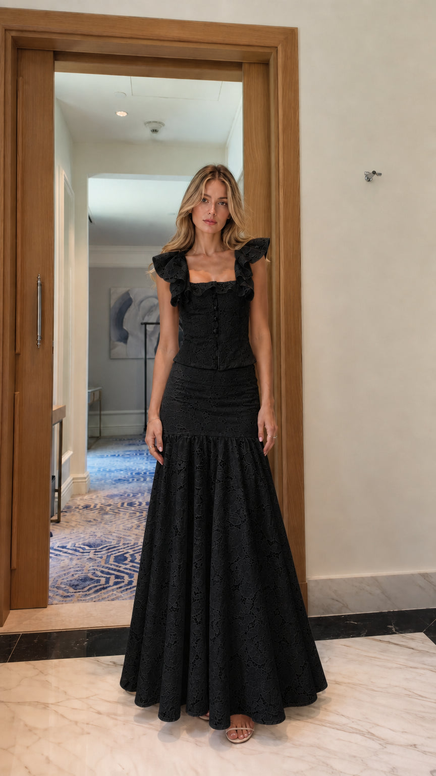 Model wearing black lace crop top and mermaid maxi skirt set