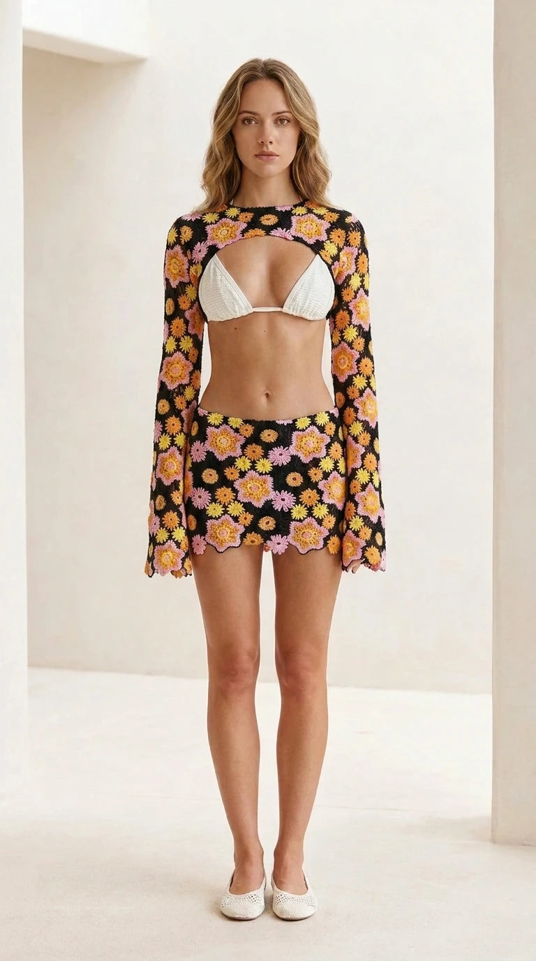 Front view of black floral crochet shrug and mini skirt set
