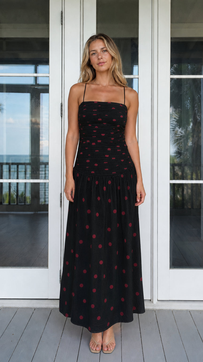 Model wearing black polka dot smocked maxi dress