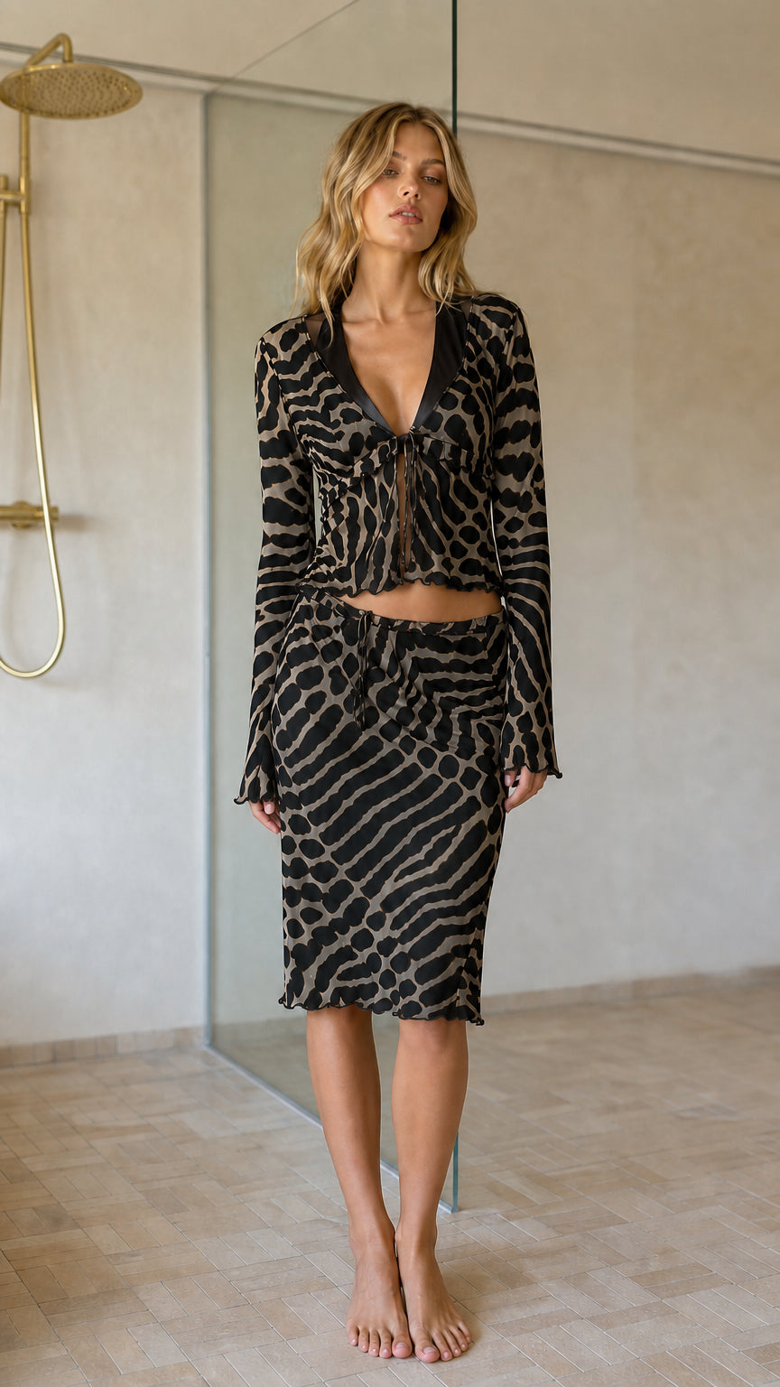Front view of black animal print crop top and midi skirt set