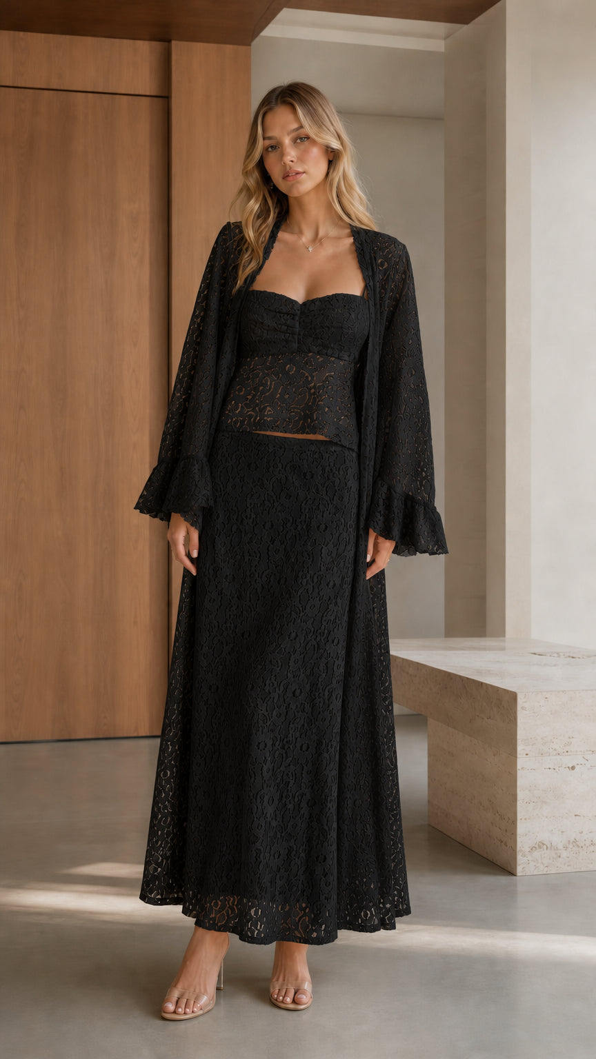 Front view of woman wearing black three-piece lace set