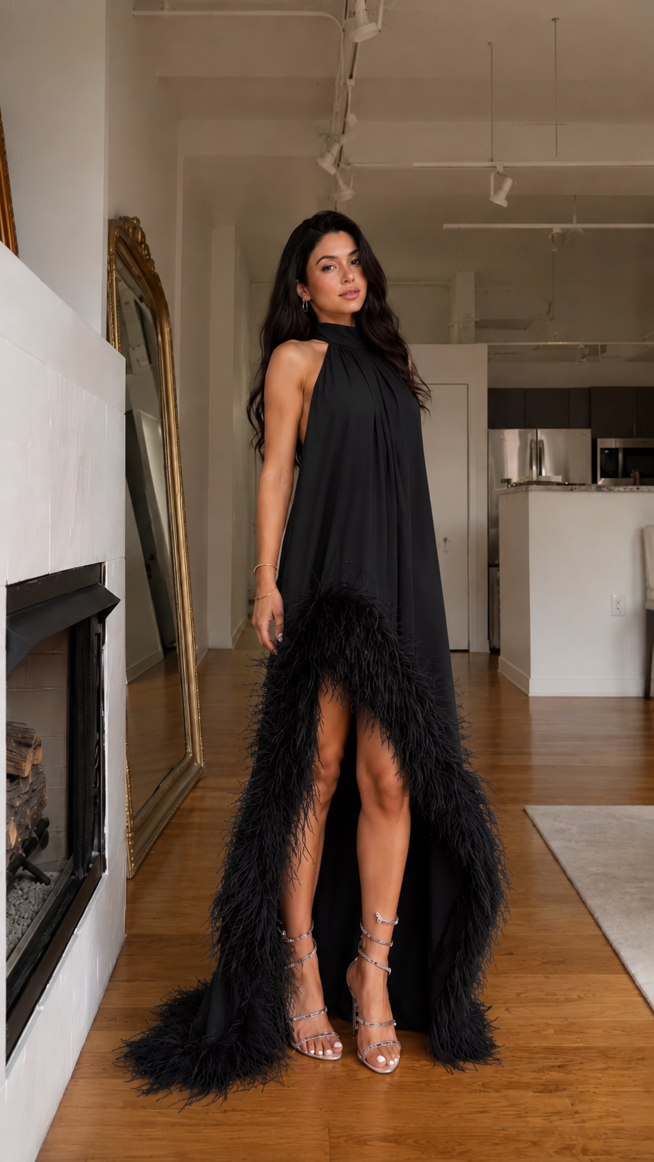 Front view of black halter high-low maxi dress with feather-trim hem