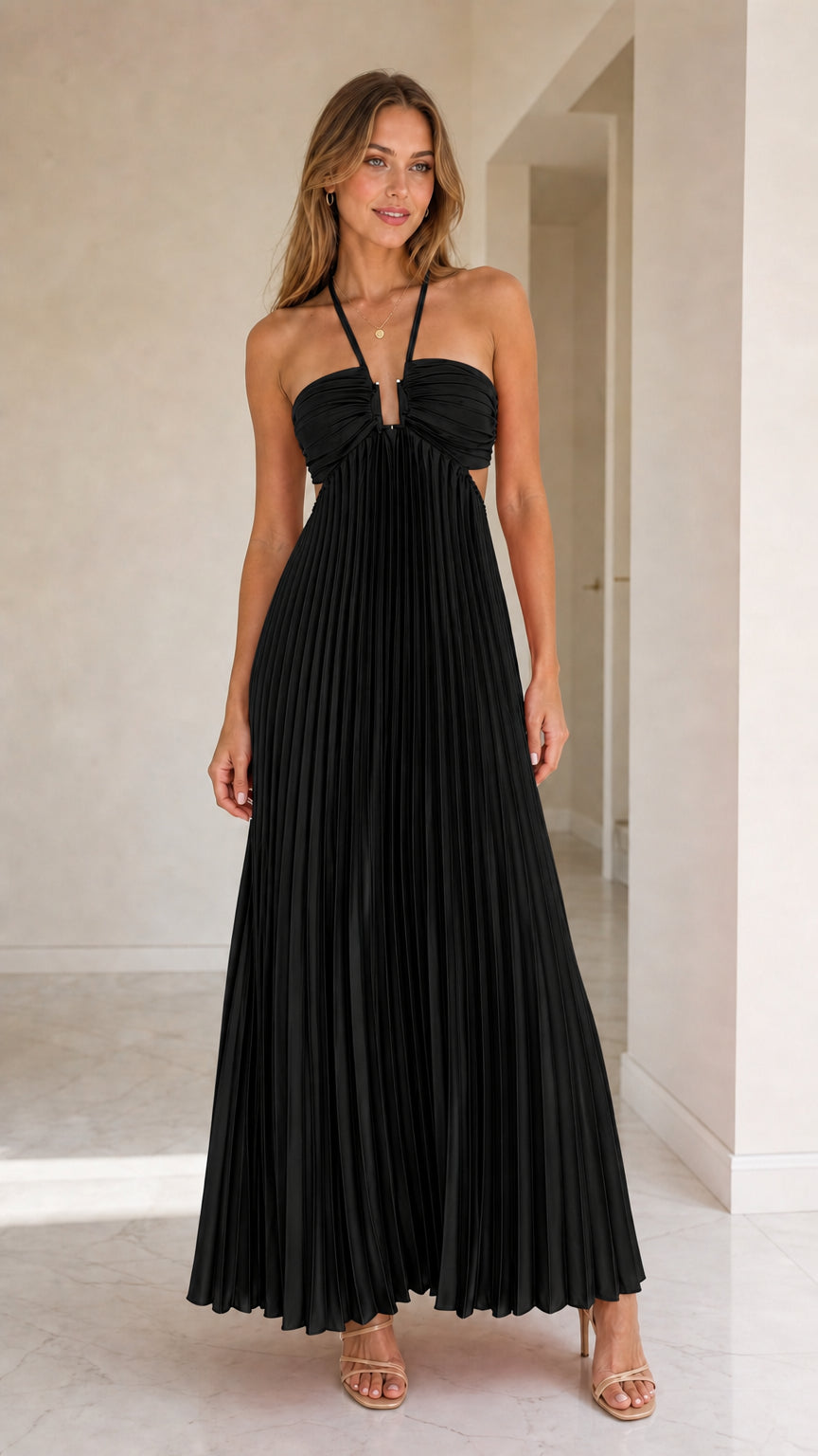 Model wearing black halter pleated maxi dress