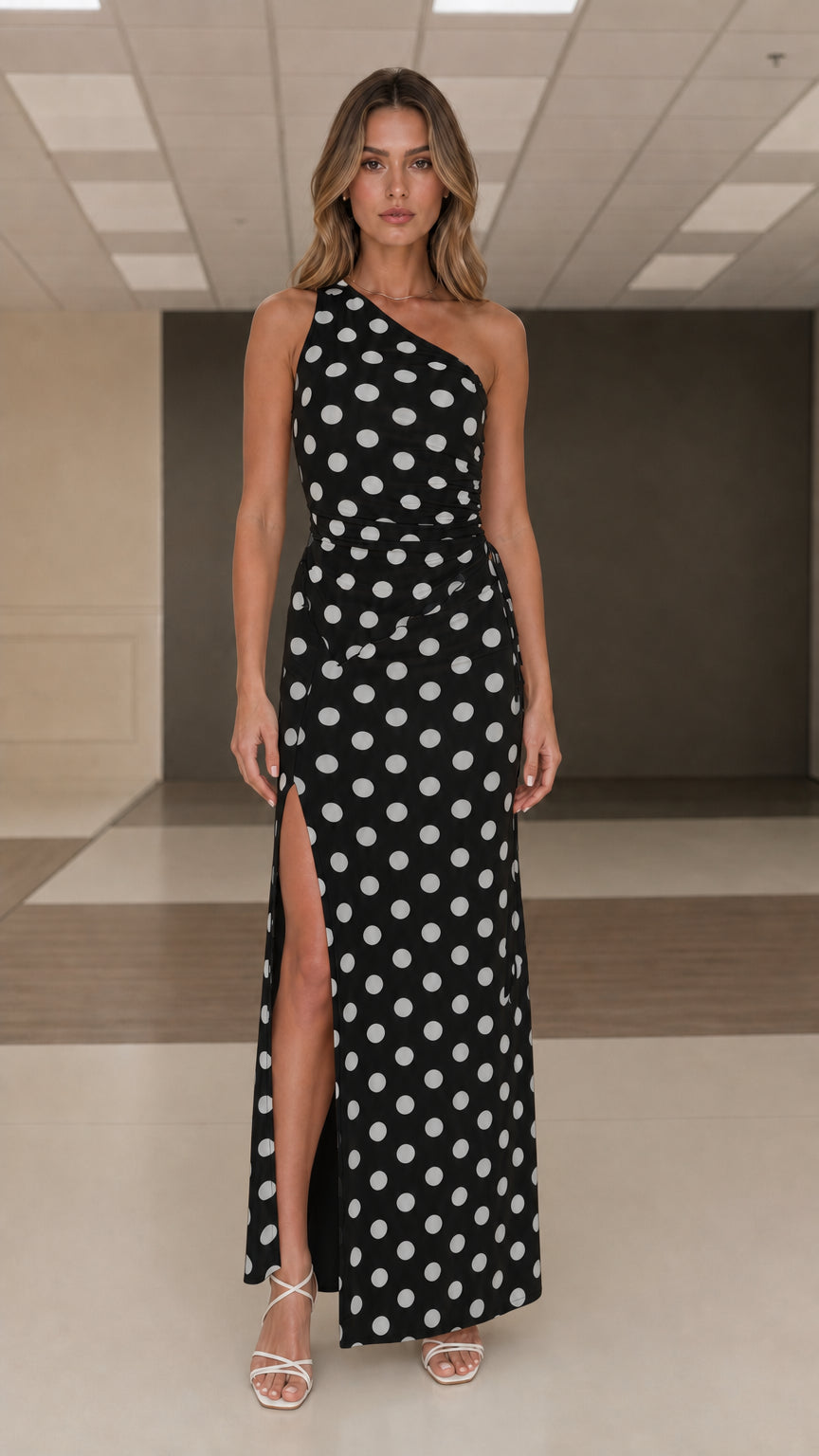 Front view of black and white polka dot one shoulder maxi dress