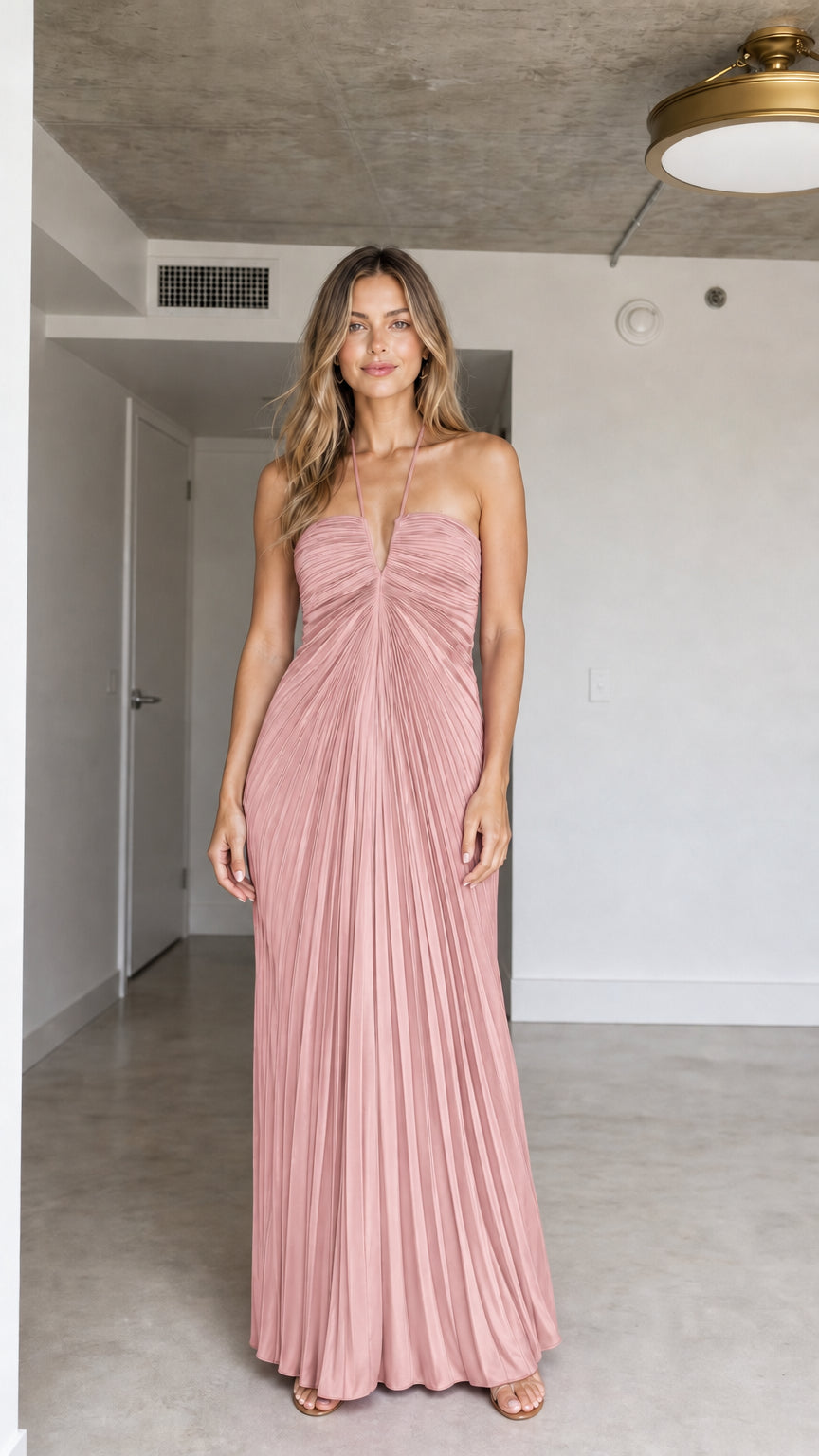 Front view of model wearing Blush Pink halter pleated maxi dress
