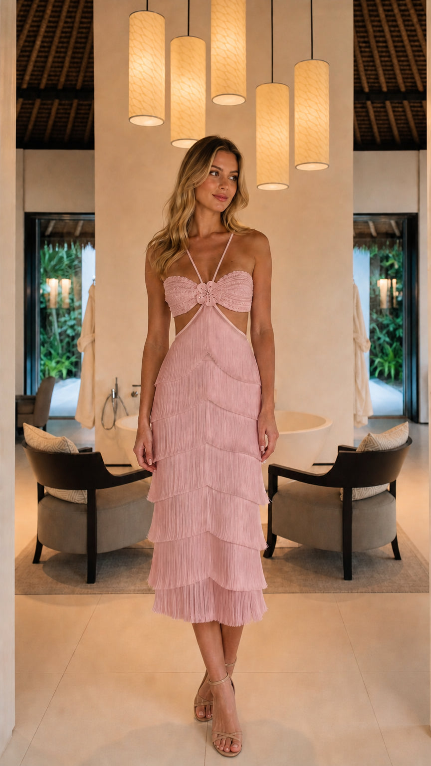 Front full view of woman wearing pink halter cut-out tiered fringe midi dress