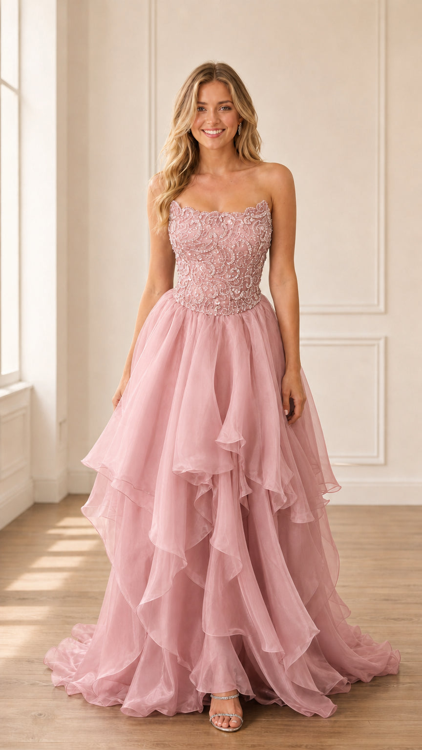 Model wearing blush pink strapless beaded tiered gown