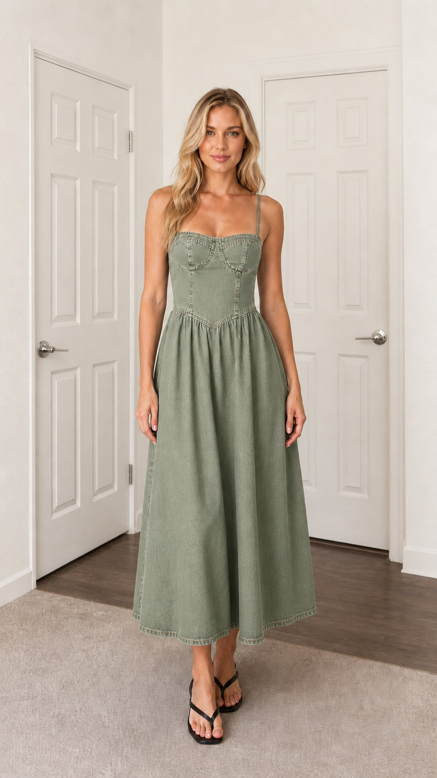 Front view of woman wearing green denim midi dress