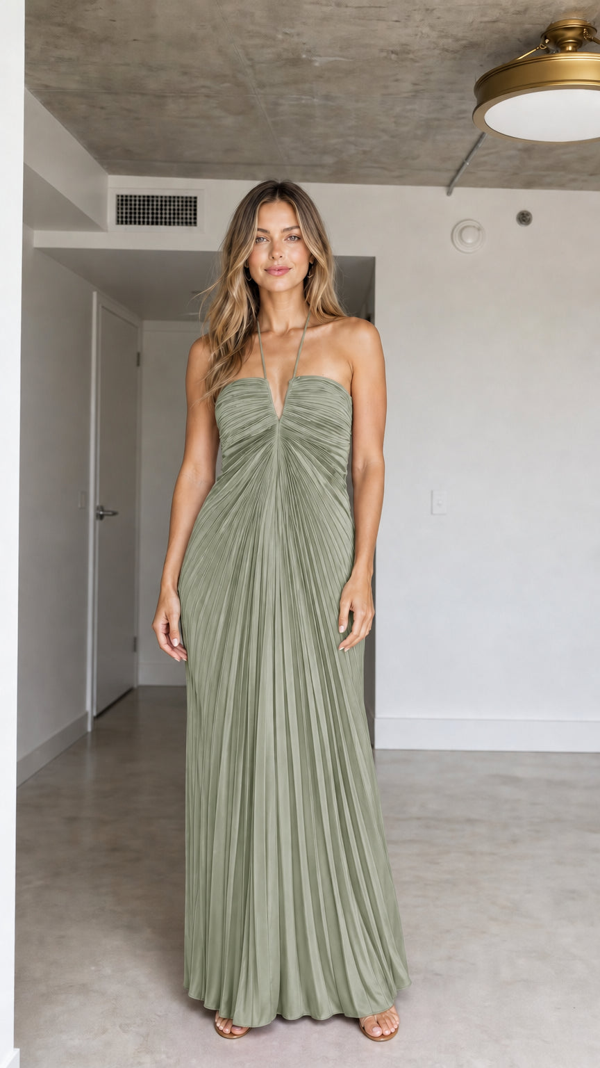 Front view of model wearing Sage Green halter pleated maxi dress
