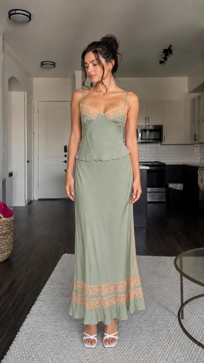 Model wearing sage green two-piece satin set