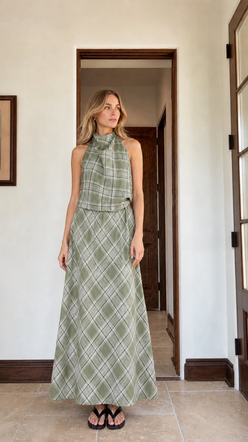 Woman wearing sage green plaid halter top and matching maxi skirt