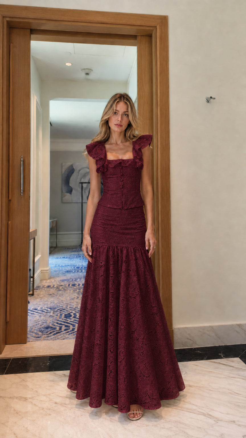 Model wearing burgundy lace crop top and mermaid maxi skirt set